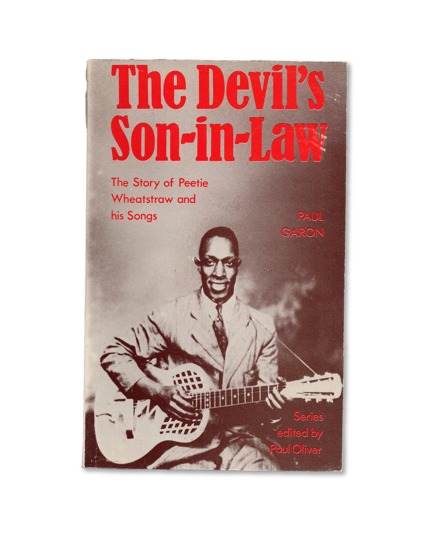Book cover of 'The Devil's Son-in-Law' by Paul Garon, with a musician holding a guitar.
