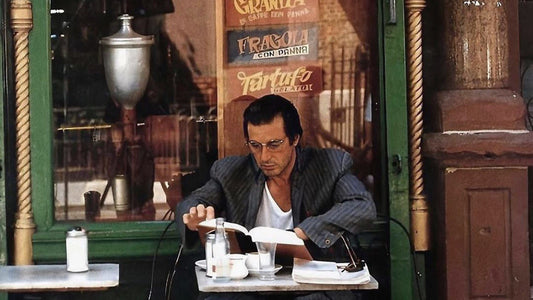 Al Pacino reading outside a cafe in New York City