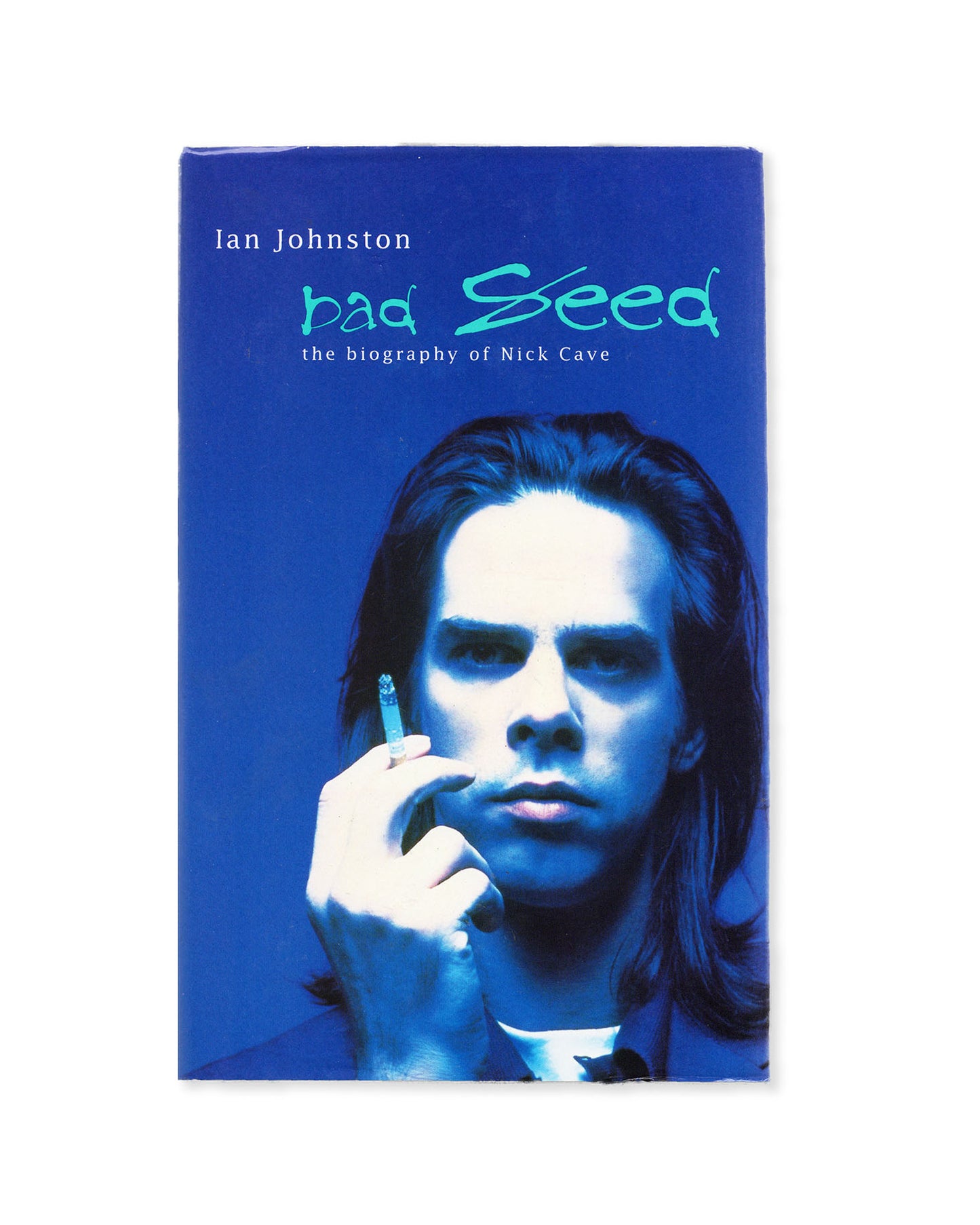 Book cover of 'Bad Seed: The Biography of Nick Cave' by Ian Johnston with a blue tint and a photo of Nick Cave smoking a cigarette 