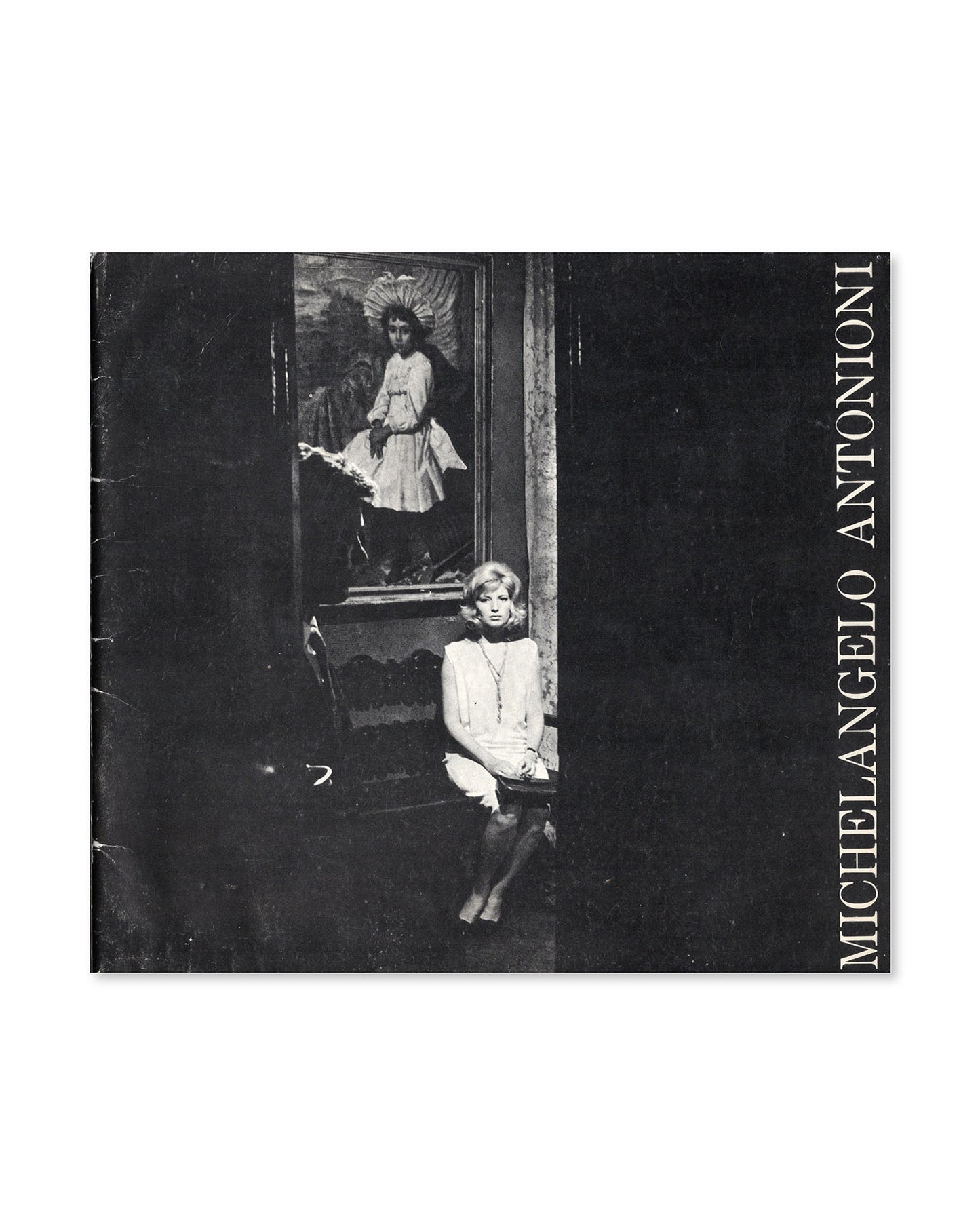 Book cover with black and white photograph of Alan Delon and Monica Vitti sitting in front of a painting, featuring the name 'Michelangelo Antonioni'.