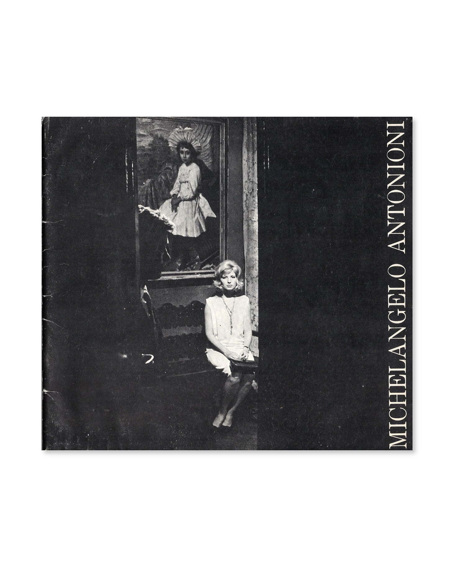 Book cover with black and white photograph of Alan Delon and Monica Vitti sitting in front of a painting, featuring the name 'Michelangelo Antonioni'.