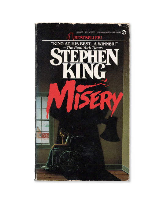 Book cover of 'Misery' by Stephen King with a dark cover and red text.