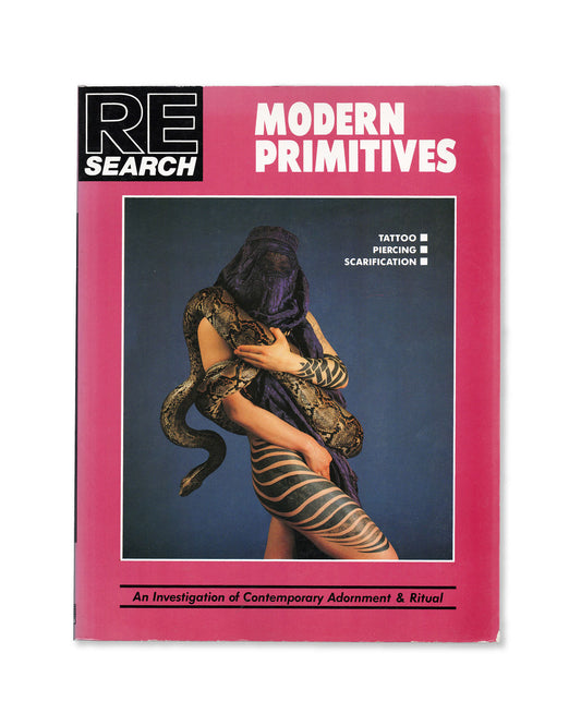 Book cover of RE/Search 'Modern Primitives' by Vivian Vale and Andrea Juno with a pink border and a central photo of a person with tattoos and a snake.