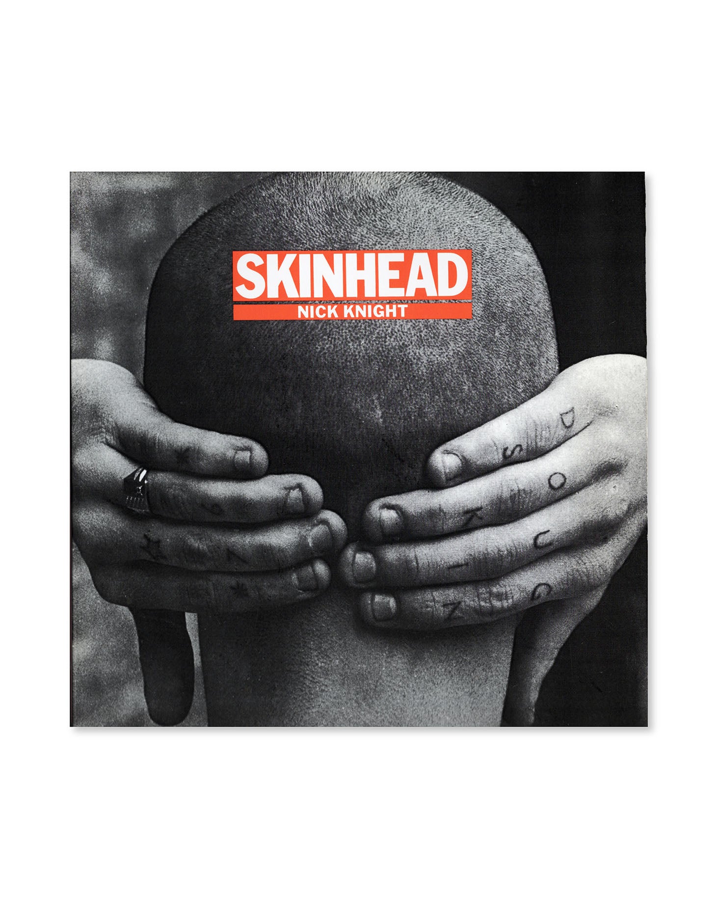 Book cover for 'Skinhead' by Nick Knight featuring a person holding their head with hand tattoos.