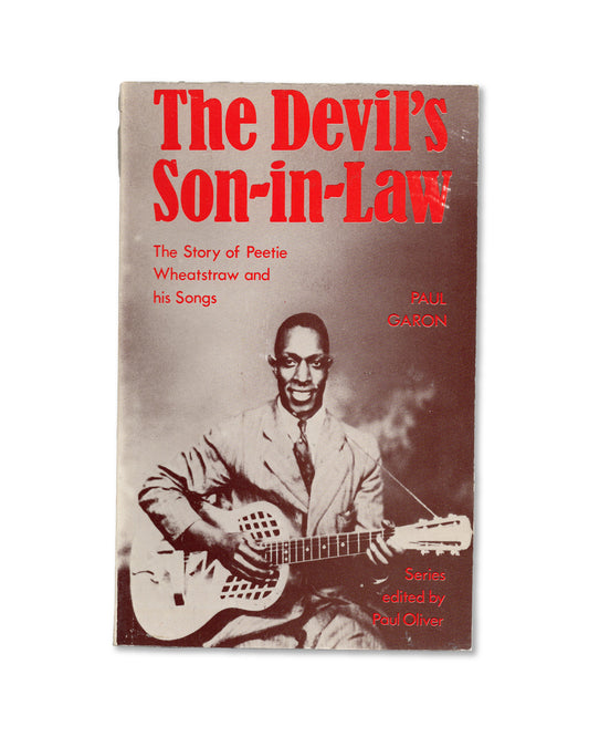 Book cover of 'The Devil's Son-in-Law' by Paul Garon, with a musician holding a guitar.